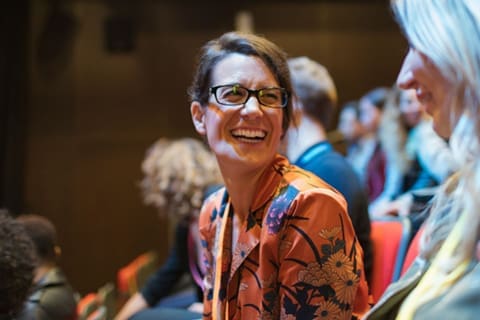 Woman Smiling at a conference